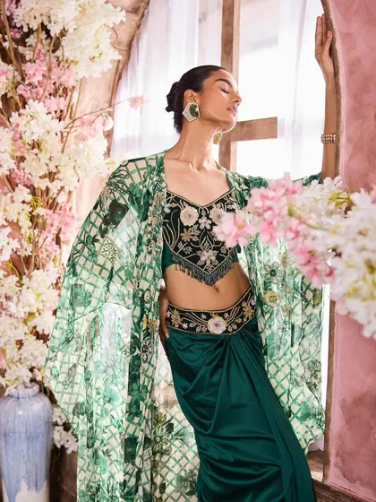 A dramatic pose showcasing an embroidered green and black outfit. I created a look with defined eyes and contoured cheeks to match the high-fashion styling.