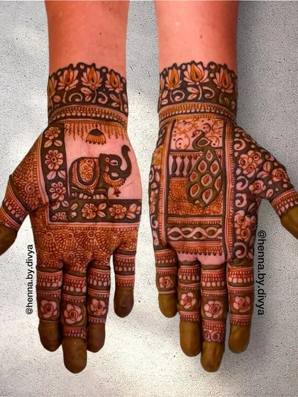 A special design for the bride's mom, featuring a royal elephant in one palm and a proud peacock in the other. It's a beautiful way to honor her at the wedding.