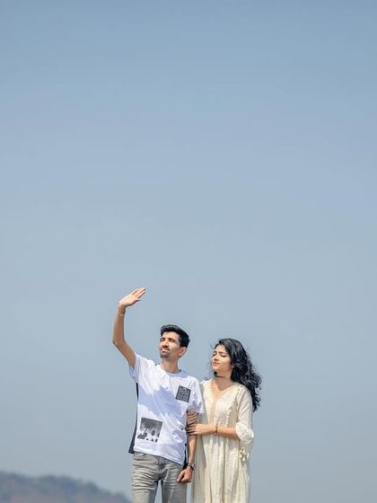 A minimalist composition with a couple against a vast, clear sky, creating a feeling of freedom and endless possibility.