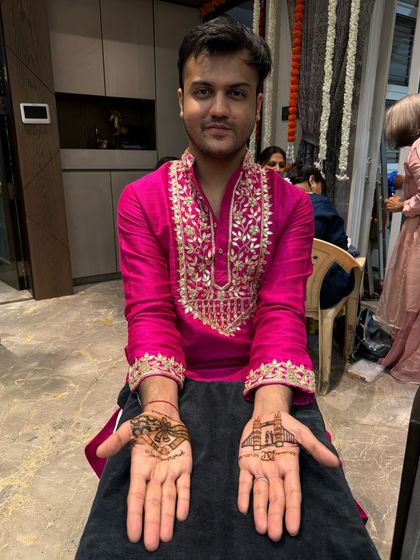 A happy groom showing off his custom design. On one hand, we have the London Bridge to represent a special place for the couple, and on the other, their wedding logo.