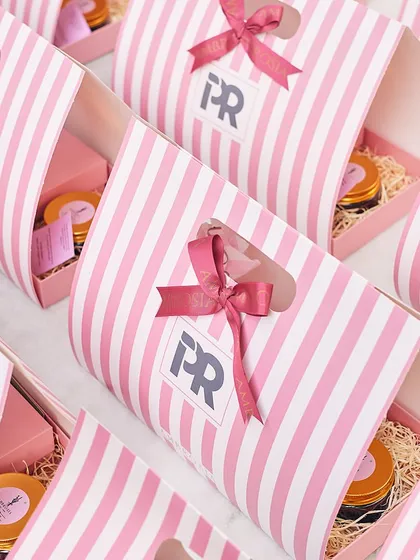 An array of our custom branded gift bags, ready for a corporate event. We work with you to create packaging that reflects your brand's identity.