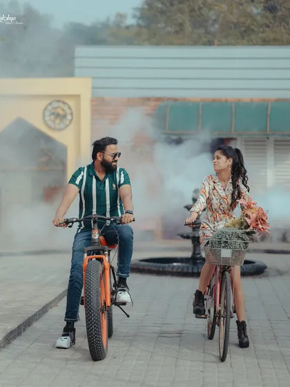 A fun and playful pre-wedding shoot with bicycles and smoke bombs. This shows that your shoot can be casual, energetic, and full of laughter, reflecting your dynamic as a couple.