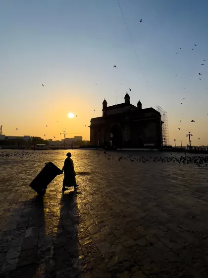 A lone traveler silhouetted against the setting sun at the Gateway of India in Mumbai. I aimed to capture a different, more personal perspective of this iconic landmark, focusing on the journey rather than the destination.