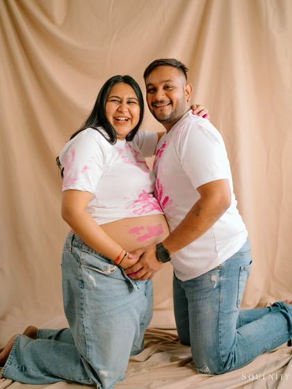 Proudly showing off their pink handprints for a girl! This is such a happy and colorful way to announce your baby's gender.