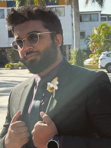A stylish groomsman wearing one of my custom boutonnieres. The single yellow-gold flower spray adds a touch of elegance and coordinates with the wedding's color theme.