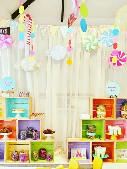 An in-store brand activation for Veneta Cucine, where I created a playful 'Candyland' theme to attract and engage customers. The setup includes a multi-level dessert bar made from colorful crates, filled with sweets and treats, all framed by whimsical candy-themed decorations.
