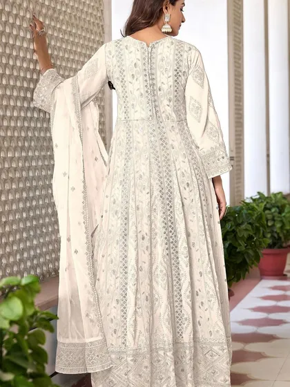 An ethereal white Anarkali suit that's perfect for any special occasion. The heavy thread, zari, and sequence work give it a divine glow.