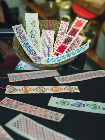 A variety of handcrafted Kasuti bookmarks ready for the Kasuti Katha exhibition in Mumbai. Each one is unique, showcasing different patterns and color combinations.