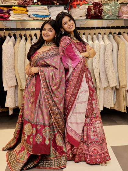 Here, two different pink and maroon lehengas from my collection are shown side-by-side. It's a great way to see how friends or bridesmaids can choose complementary styles for an event.