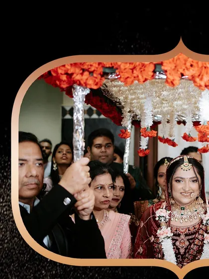 The bride's entry under a traditional 'phoolon ki chaadar', a timeless and emotional moment.