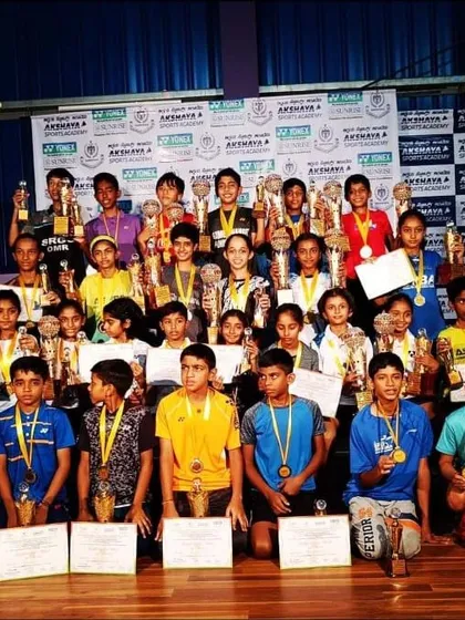 A moment of pride for our academy. This group photo shows our young champions after a successful tournament, holding their well-deserved trophies and medals, representing the collective success of our training programs.