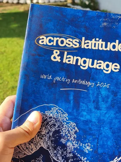 A close up of our global anthology, 'Across Latitude & Language,' from the World Poetry Project. The cover design reflects its theme of connecting the world through poetry.