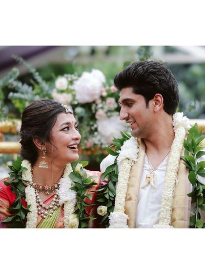 A happy, candid moment between the bride and groom during their garden-themed Muhurtham ceremony.