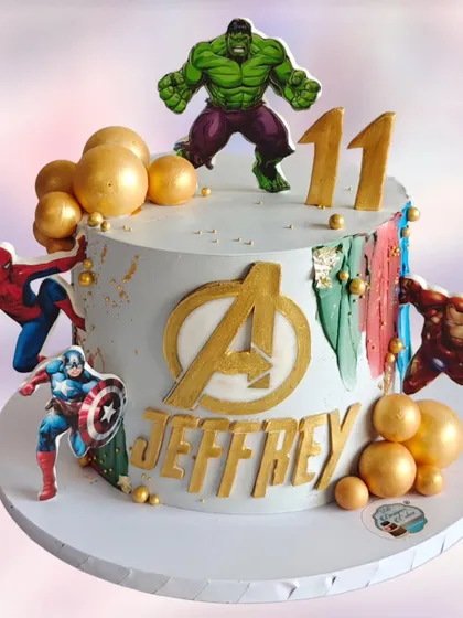 An impressive Avengers-themed cake for an 11th birthday. This design features Hulk, Spider-Man, Captain America, and Iron Man around the iconic Avengers logo.