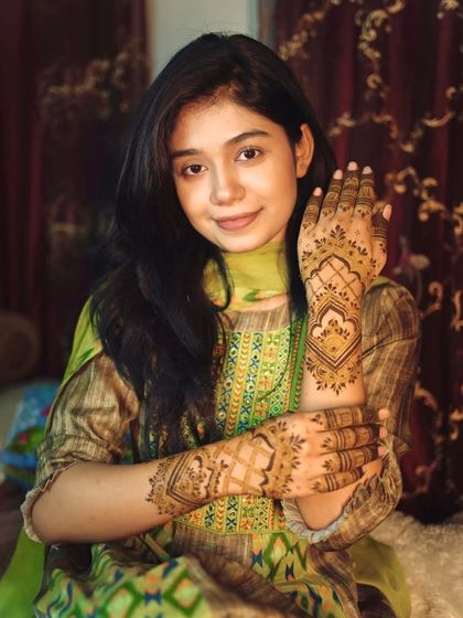 Another pose from a happy client. Her smile shows how much she loves her beautiful, traditional mehndi.