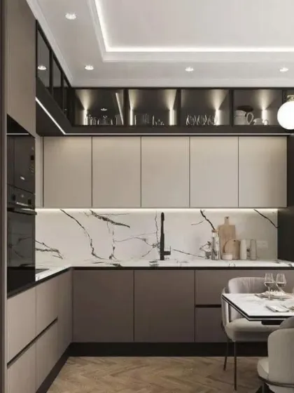 An open kitchen and dining concept. The kitchen features two-tone cabinets and a marble backsplash, while seamlessly connecting to the dining area.