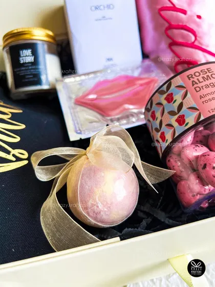 A close-up on the details, like this shimmering bath bomb tied with an organza ribbon, part of a luxurious bridal pamper kit.
