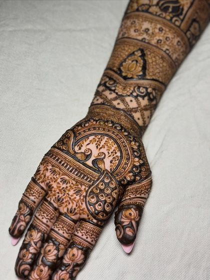 A detailed look at the palm, featuring two peacocks in a garden, a classic and romantic motif.