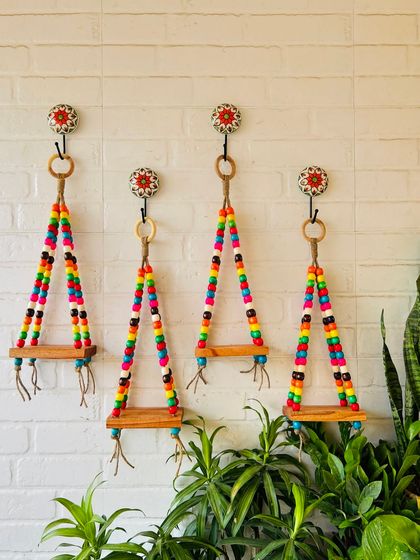 A set of four colorful beaded wall shelves, perfect for adding a vibrant and aesthetic touch to your space.