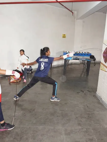 Two students work together on a target drill, with one observing and learning from the other. This collaborative approach enhances the learning experience.