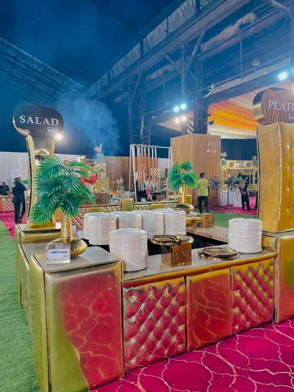 The plate and salad counters, with their striking red and gold design, ready for a large-scale event.