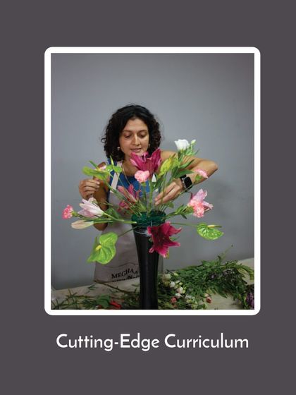 My curriculum is cutting-edge, blending timeless principles with modern trends. This student is working on a contemporary piece, reflecting what's current in the floral design world.
