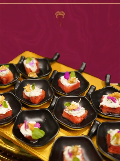 A refreshing appetizer of watermelon cubes topped with feta cheese, walnuts, and fresh mint. This light and flavourful bite is perfect for summer events.