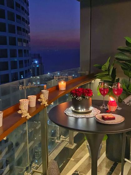 Another angle of the terrace dinner, showing how the simple decor elements create a special moment. The candles lining the railing add to the romantic ambiance.
