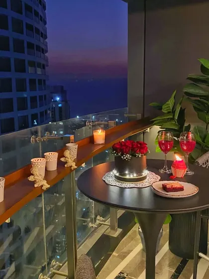 Another angle of the terrace dinner, showing how the simple decor elements create a special moment. The candles lining the railing add to the romantic ambiance.