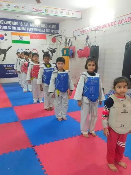 Our little warriors in their chest guards, ready for a sparring session. Safety is our top priority.