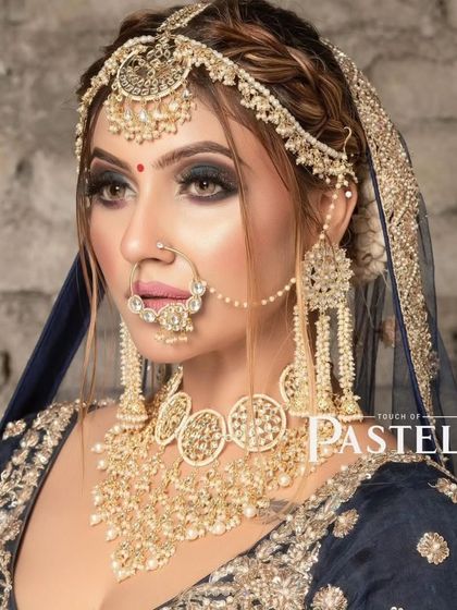 A model wearing a unique, oversized choker and matching long earrings. This bold look is available for rent.