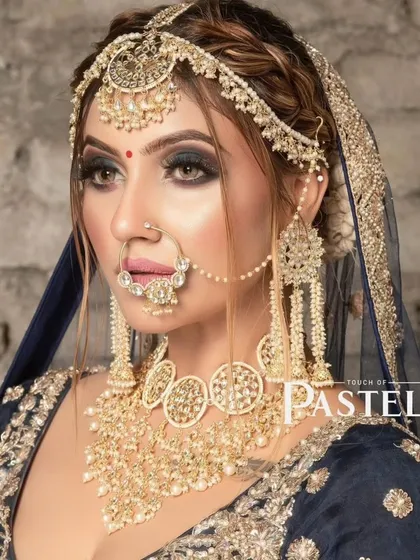 A model wearing a unique, oversized choker and matching long earrings. This bold look is available for rent.