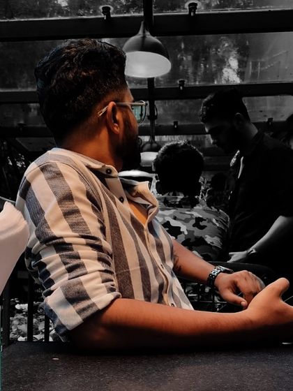 Facing the world? Nah, I'll let the spotlight chase me. A candid, black and white moment reflecting my personality.