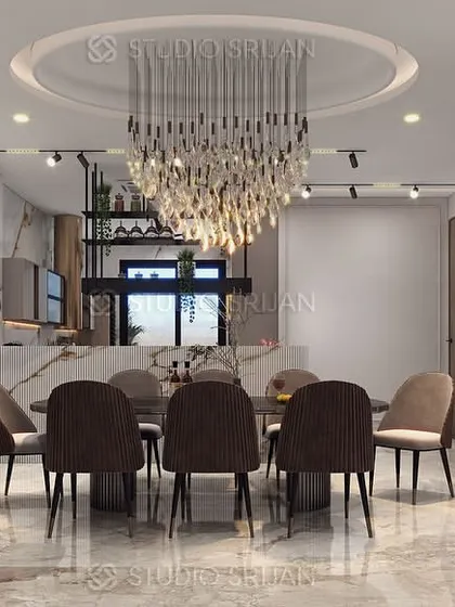The dining area in the Janakpuri residence, defined by a grand crystal chandelier and a circular ceiling detail. Mirrored walls and elegant furniture complete the formal, luxurious look.