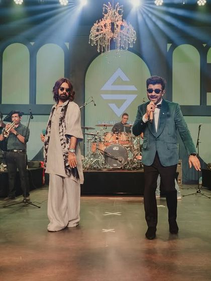 We bring in top-tier entertainment to elevate the night. Here, a live performance by Sachin-Jigar gets the crowd energized on a stage complete with grand chandeliers and professional lighting.