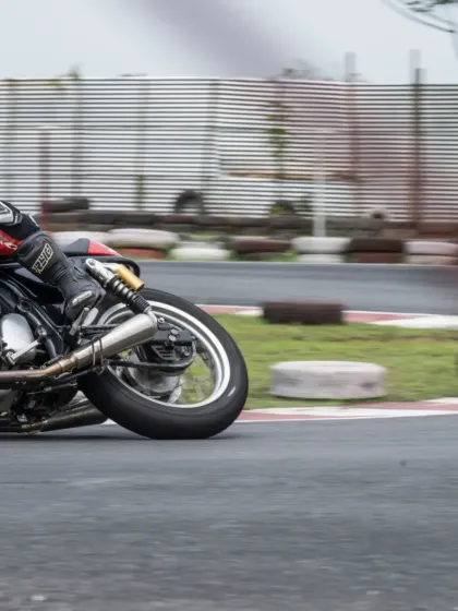 A close-up shot of a rider cornering during the RE GT Cup Zonal Selection in Guwahati, highlighting the challenging track conditions.