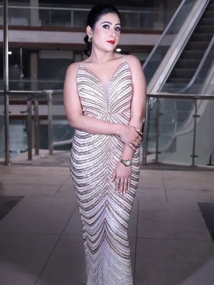 A full-length shot of the rose gold sequin gown, emphasizing its sleek, bodycon silhouette.