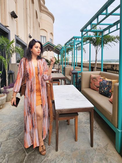 Another view of the orange dress and printed shrug, showing how it flows and moves.