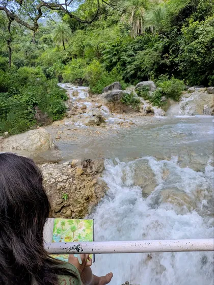 This moment captures the soul of what I do. We met this young art student painting a waterfall, completely lost in her creation. This is the magic I want to share: the joy of pausing to create.