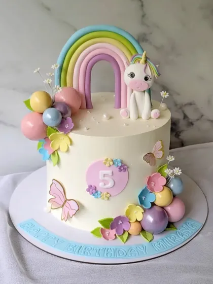 It's a rainbow and unicorn kind of day. This cake features a pastel rainbow, a sweet little unicorn, and colorful flowers and butterflies.