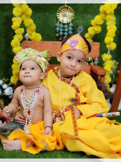Two adorable brothers posing for their Janmashtami photoshoot. We are experienced in directing multiple children to create a perfectly composed and joyful family portrait.