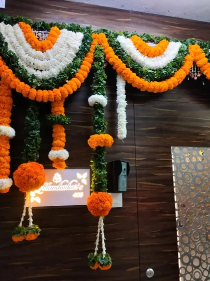 A patriotic and traditional door decoration using marigold garlands in the colors of the Indian flag. This design is perfect for national holidays or themed events.
