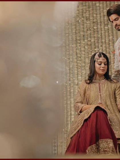 An artistic shot of Shrey and Shreya, with a dreamy, out-of-focus foreground element. This technique adds a layer of cinematic romance to their Sufi night portrait.