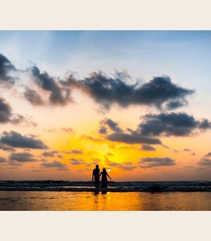 A beautiful silhouette of the couple against a golden sunset on the beach. This pre-wedding shot is the perfect picture of romance and tranquility.