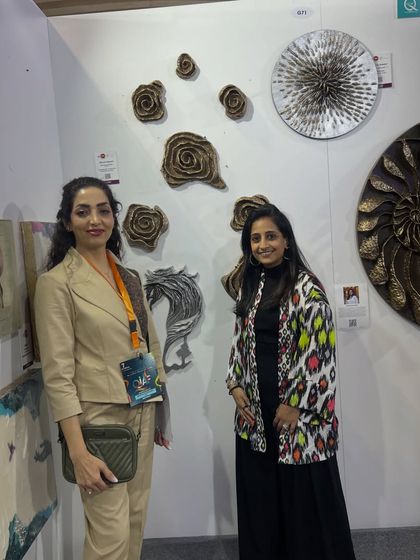 Posing with a visitor at my booth in Qatar. The connections made at these shows are just as important as the art itself.