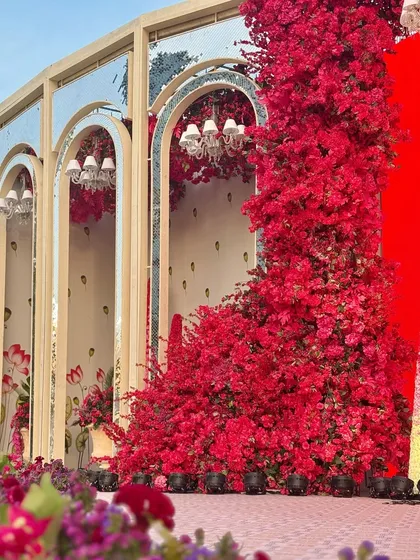 A detail of the mirrored arches, which reflect the vibrant red flowers, creating an illusion of even greater depth and color.