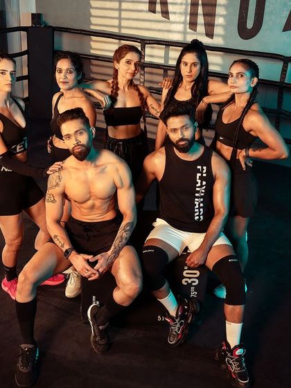 A group shot of me, my partner, and my female clients at the photoshoot, showcasing the strong, supportive community we've built.