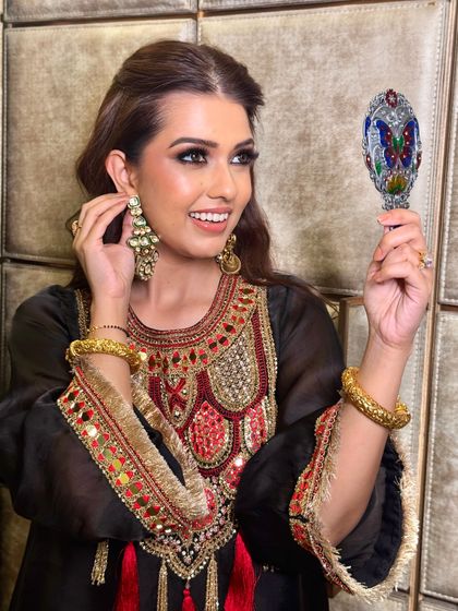 A candid moment of this beauty getting ready for Diwali. The makeup is glamorous and festive, perfect for the season of lights.