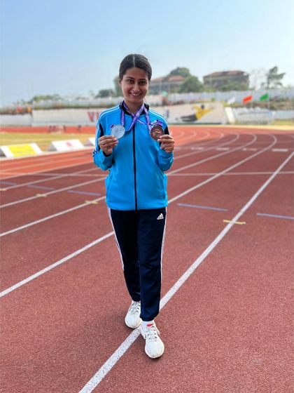 Posing with her hard-earned silver and bronze medals on the track. This para-athlete is an inspiration to everyone at the academy.