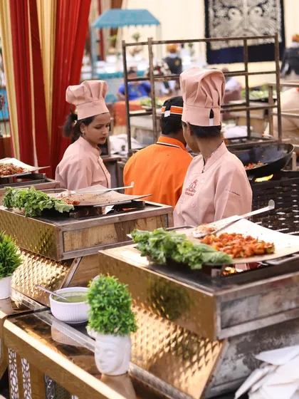 My live grill stations are perfect for adding sizzle to any event. Here, my female chefs in pink uniforms prepare delicious grilled appetizers, offering guests a fresh and interactive dining experience.